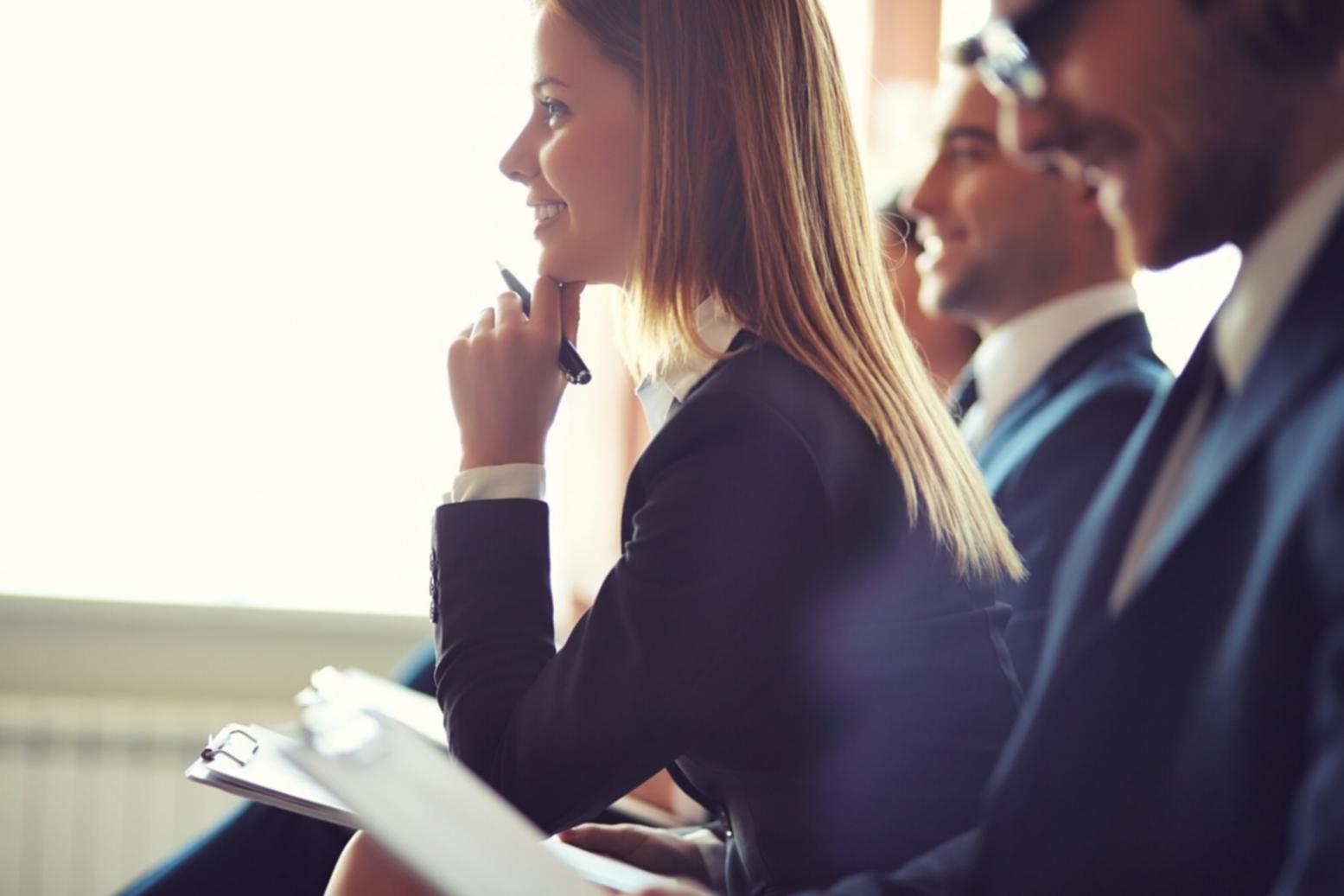 Financial analysts reviewing market data and competitive intelligence reports on multiple screens